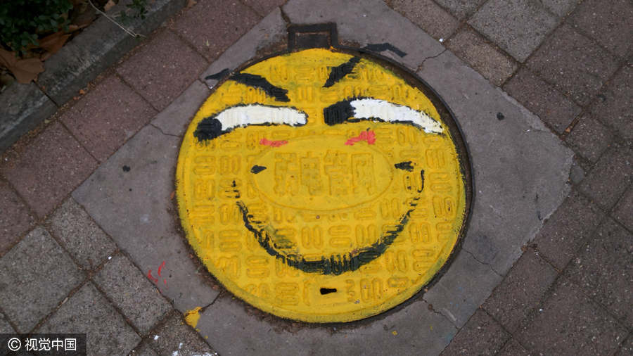 PHOTOS: Chinese College Students Turn Manholes into Art