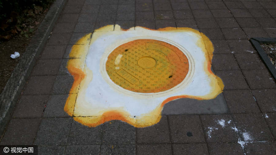 PHOTOS: Chinese College Students Turn Manholes into Art