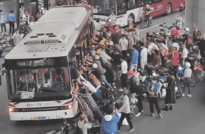 WATCH: Crowd of People Lift Bus to Save Man