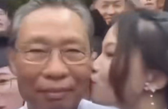 WATCH: China COVID Expert Cheekily Kissed at Graduation Ceremony