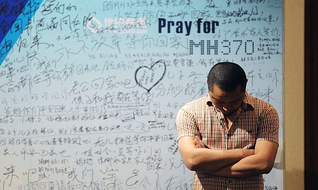 A relative of a MH370 passenger waits to hear news in April 2014