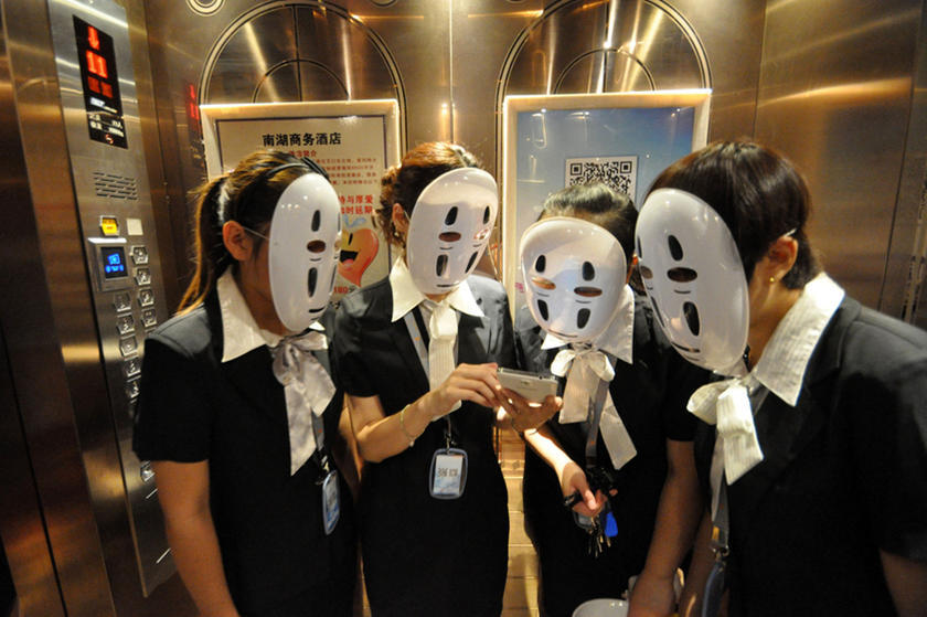 Office workers wear masks on a faceless day at a Chinese company in Handan