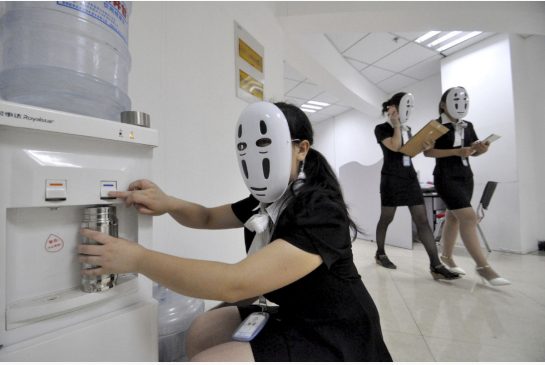 Office workers wear masks on a faceless day at a Chinese company in Handan