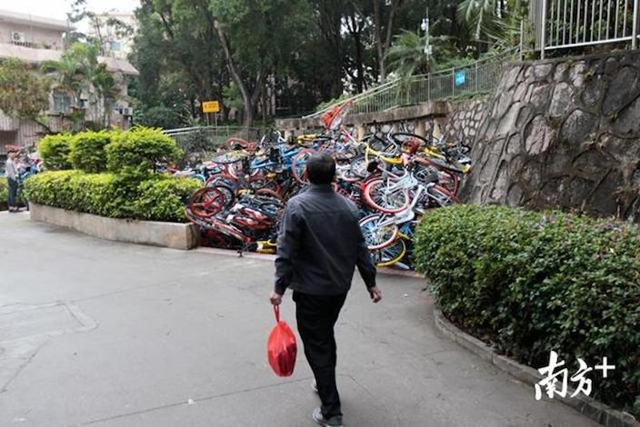 bike-pile-shenzhen-man-walks.jpeg