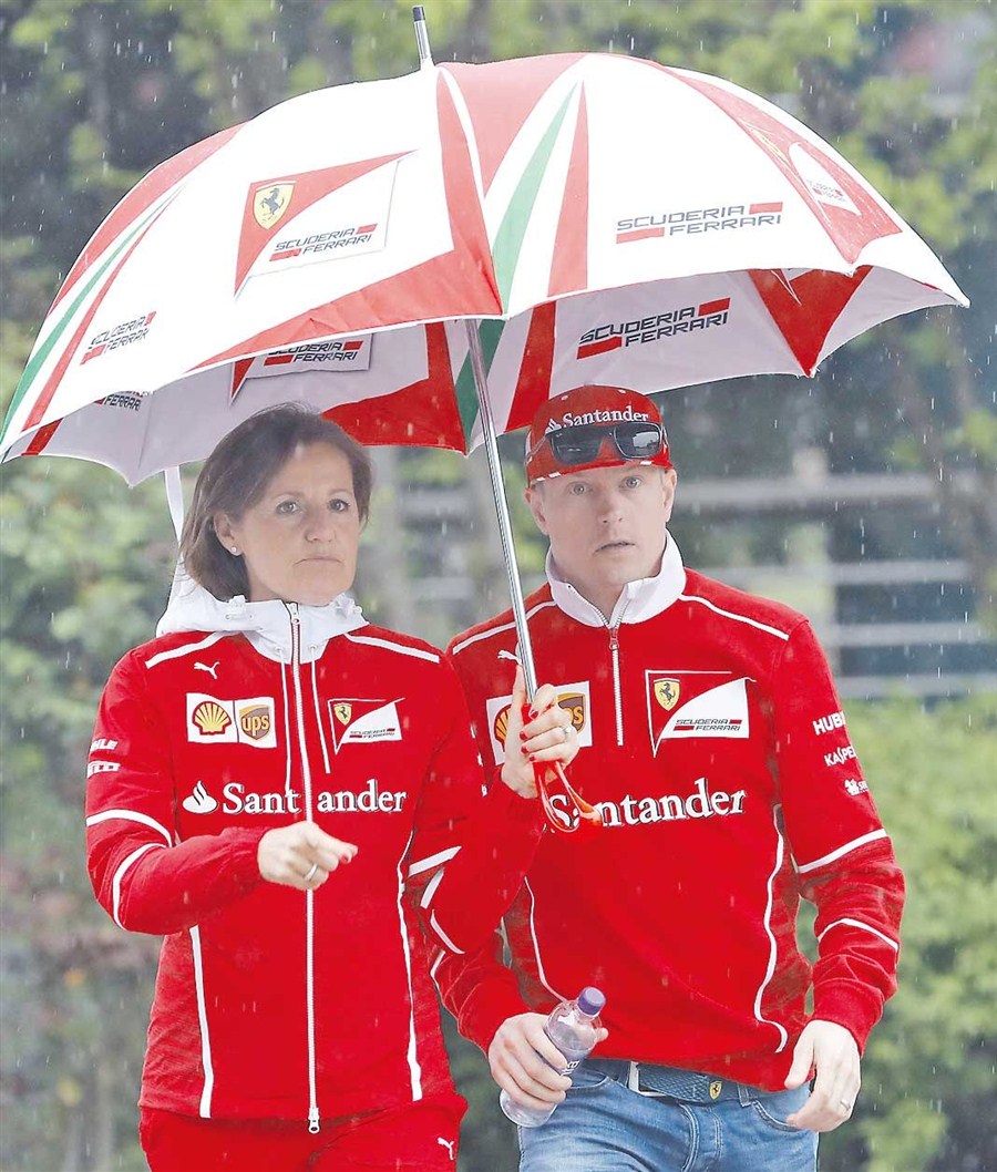 Ferrari's Kimi Raikkonen walks in the rain — That's Shanghai — thatsmags.com