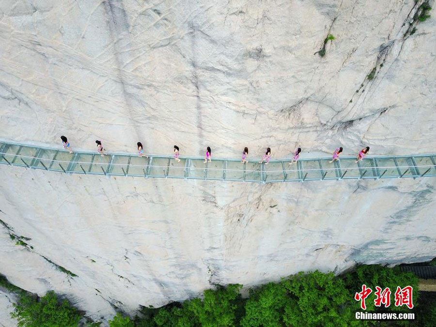 PHOTOS: Bikini Clad Models Pose on Vertical Cliff in Henan