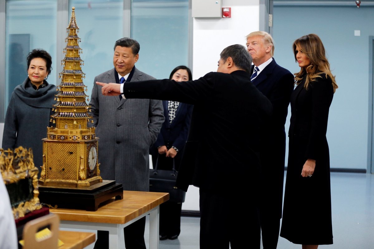 PHOTOS: Trump Visits Forbidden City, Tries to Pick Up Gold Vase